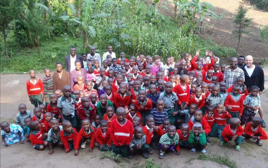 Children and teachers gathered outside a school funded by a Peace Pedalers grassroots charity project